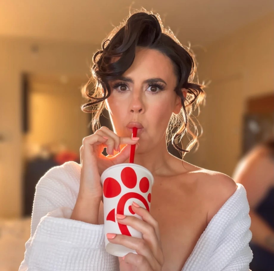 Chef Tzarina drinking from a cup in a hotel room
